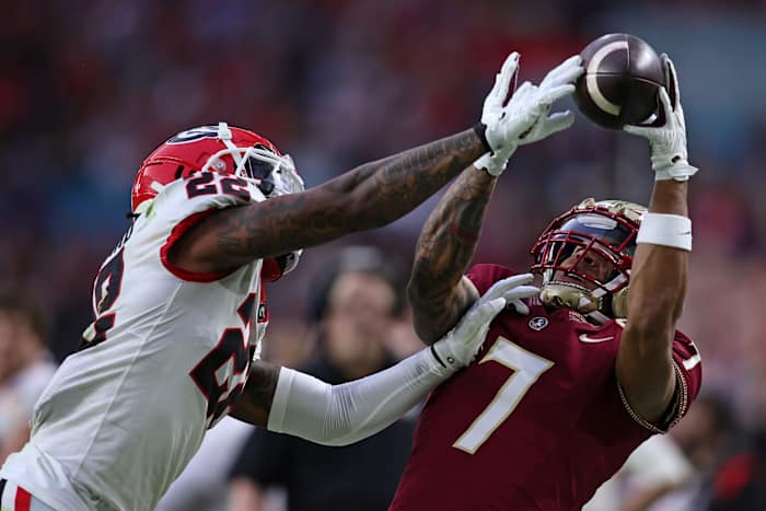 Dec 30, 2023; Miami Gardens, FL, USA; Florida State Seminoles wide receiver Destyn Hill (7) attempts to make a catch against Georgia Bulldogs defensive back Javon Bullard (22) during the first half in the 2023 Orange Bowl at Hard Rock Stadium. Mandatory Credit: Sam Navarro-USA TODAY Sports